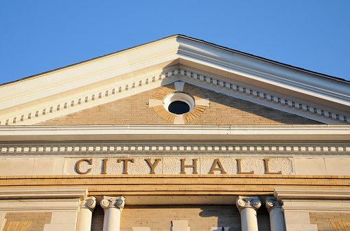 Building with city hall sign, horizontal.