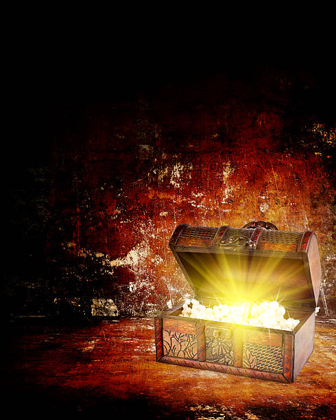 istock Open treasure chest with a golden glow coming from inside it 184663161