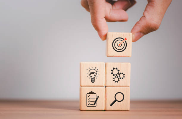 istock Businessman in selecting Wood cube block stacking with icon. business strategy and action plan Concept. 1846644840