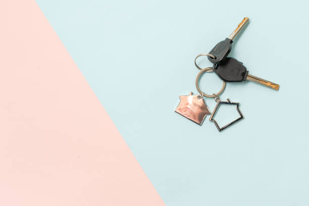 istock Keys with keychain with shape of house on two colored background 1846678372