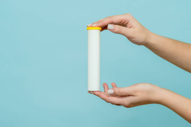 istock Tube for vitamins, pills in hand. Packaging. Mockup 1846678900