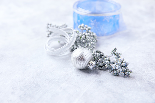 Christmas ornaments on a bright stone background. Soft focus. Copy space.