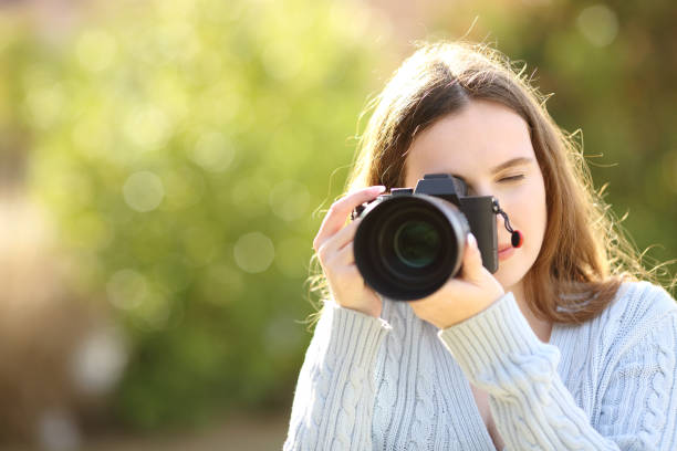 istock Photographer in a park taking photos 1846726157