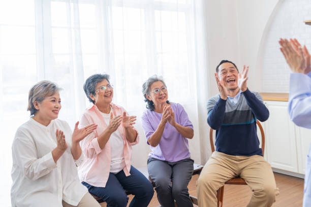 senior females and male sitting on bench. older people are listening and enjoy meeting focus group at living room. joyful carefree retired senior friends enjoying relaxation at nearly home. - senior adult human face male action imagens e fotografias de stock