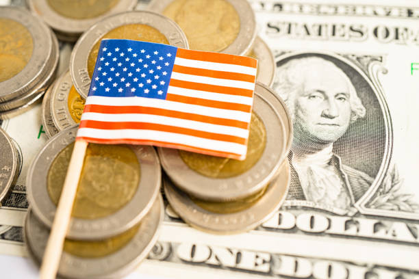 istock Stack of coins with USA America flag and US dollar banknotes. 1846735269