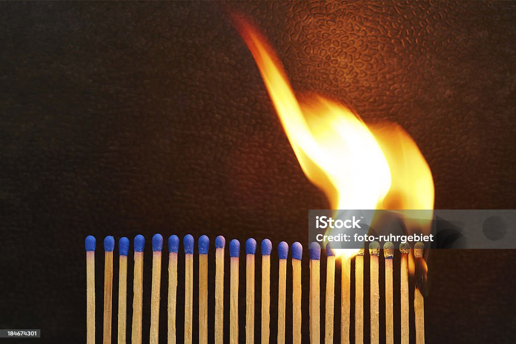 Burnout A series of matches are next to each other, which burn one after another. Blue Stock Photo