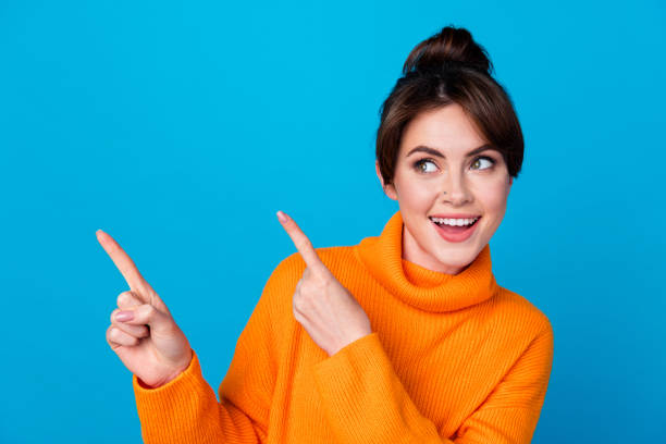 istock Photo of excited funky lady wear knitted pullover pointing two fingers looking empty space isolated blue color background 1846755339