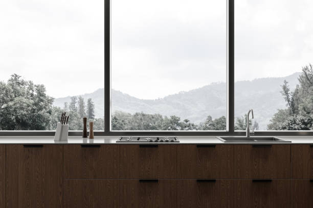 istock Modern home kitchen interior with sink and stove, panoramic window 1846769138
