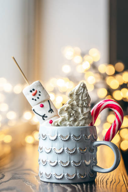 istock Hot drink with marshmallows, gingerbread and candy cane in mug. 1846771265