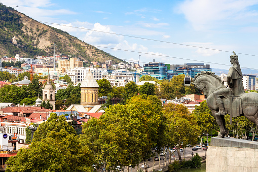 Tbilisi, Georgia - September 26, 2023: view of old Tbilisi city with Sioni cathedral and monument to King Vakhtang Gorgasali from Metekhi on sunny autumn day