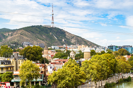 Tbilisi, Georgia - September 26, 2023: view of Georgia Tbilisi TV Broadcasting Tower on Mtatsminda hill over old town on waterfront of Kura River in Tbilisi city from Metekhi viewpoint on autumn day