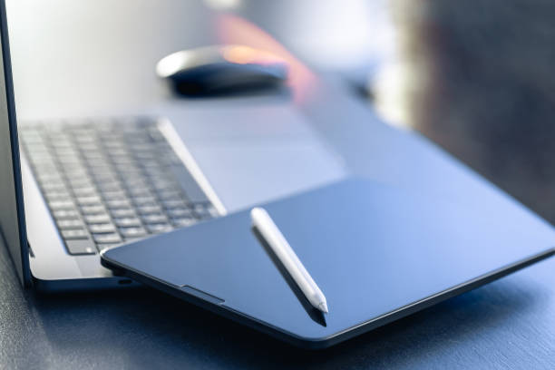 istock Digital tablet, stylus pen and laptop on the desktop, close up. 1846774544