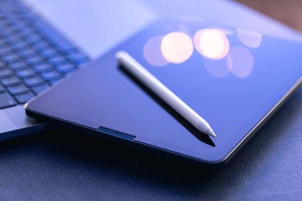 istock Digital tablet, stylus pen and laptop on the desktop, close up. 1846775068
