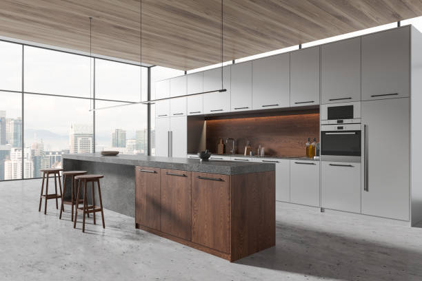 istock Stylish home kitchen interior with bar island, cooking shelves and window 1846779866