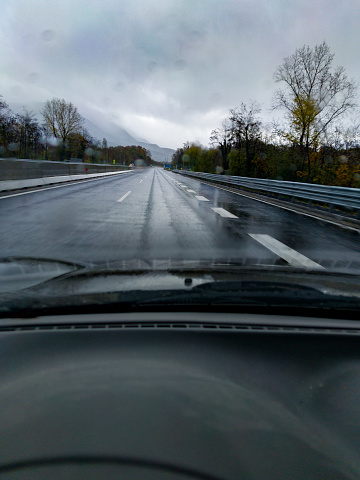 Driver View of the Wet Road Through the Windshield in a Rainy Day Driving on Motorway