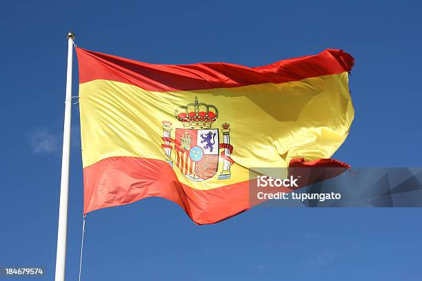 Flag Of Spain Waving In Breeze With Blue Sky Behind Stockfoto en meer beelden van Spaanse vlag