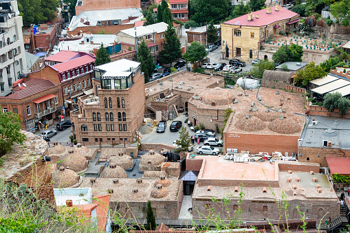 Tbilisi, Georgia - September 23, 2023: above view of Abanotubani ancient sulphuric baths buildings in Tbilisi city from Sololaki hill on cloudy autumn day