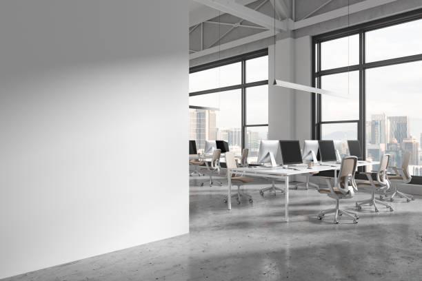 istock White office coworking interior with pc desktop and window, mock up wall 1846802845