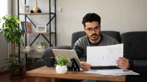istock Young handsome man examining files at home 1846806440