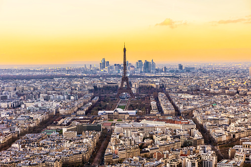Aerial sunset view of Paris with Eiffel tower from Montparnasse Tower, France.