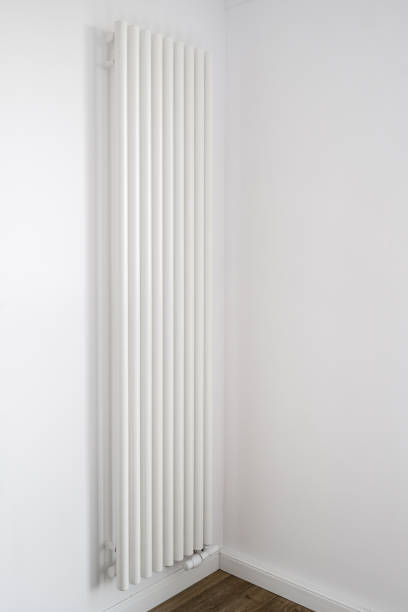 istock Vertical radiator install on white wall in empty room with minimalist interior 1846840915