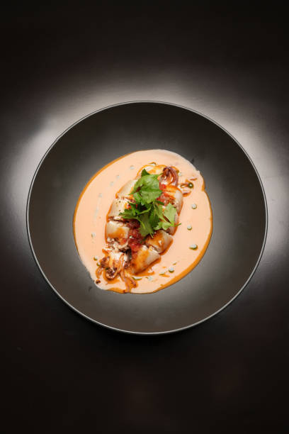 istock Baked squid stuffed with vegetables and sauce. Stuffed calamari 1846841483