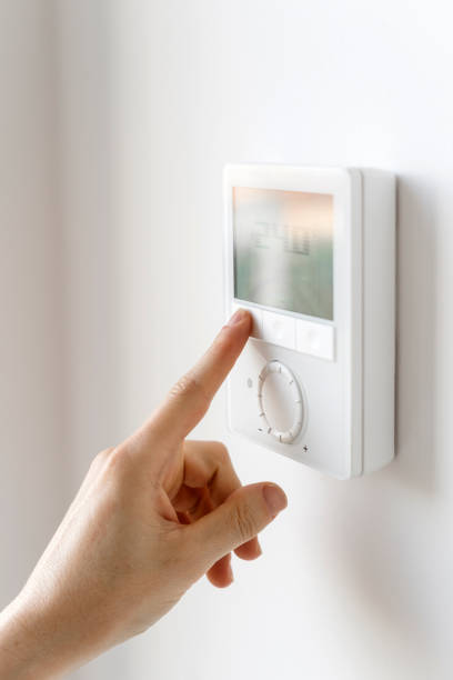 istock Home thermostat with digital panel for adjusting central heating or air conditioner 1846844218