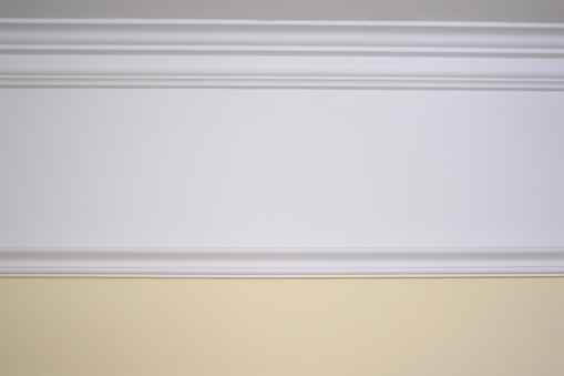 Detail of a flat ceiling skirting, ceiling moldings in the interior. Details of the ceiling.
