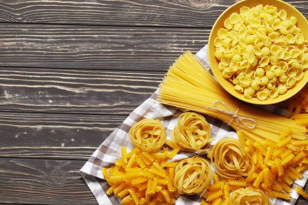 istock Composition with different Uncooked pasta, on a wooden background. top view. Place for text. 1846867126