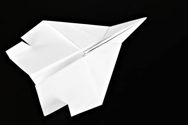 istock White paper plane isolated on black background. 1846877880