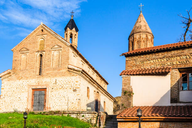 Church of St George in Sighnaghi town in Kakheti travel to Georgia - Church of St George lit by sunset sun in old Sighnaghi town in Kakheti region in Georgia in autumn evening kakheti georgia stock pictures, royalty-free photos & images