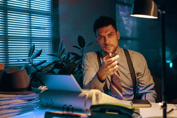 istock Young serious businessman in formalwear looking at camera by workplace 1846884869