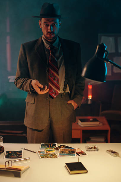istock Young elegant man in old-fashioned suit and hat looking at camera 1846885990
