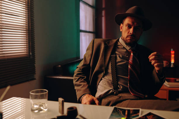 istock Confident man in formalwear sitting by workplace in dark office 1846885996