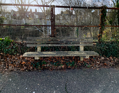 Old wooden bench by a railway line in Southend, Essex