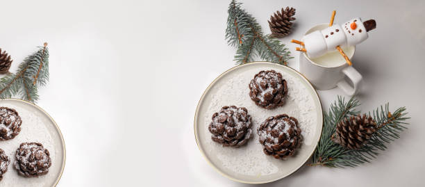 Christmas tree cone shaped cookies with chocolate flakes with powdered sugar, a delightful homemade dessert for the New Year. a chocolate pine cone-shaped shortbread cookies with sweet snow, rotation