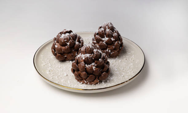 Christmas tree cone shaped cookies with chocolate flakes with powdered sugar, a delightful homemade dessert for the New Year.