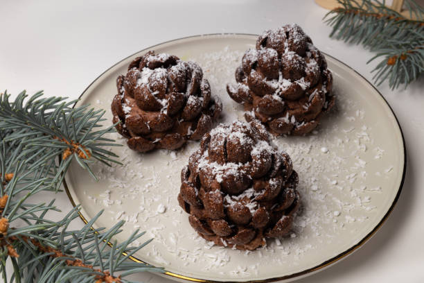 Christmas tree cone shaped cookies with chocolate flakes with powdered sugar, a delightful homemade dessert for the New Year.