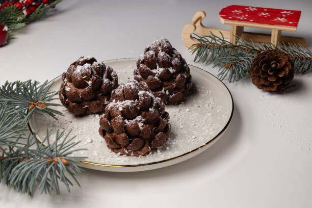Christmas tree cone shaped cookies with chocolate flakes with powdered sugar, a delightful homemade dessert for the New Year.