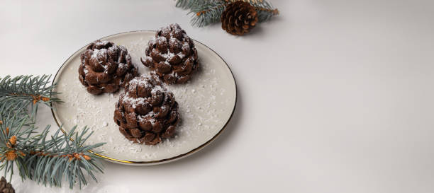 Christmas tree cone shaped cookies with chocolate flakes with powdered sugar, a delightful homemade dessert for the New Year.
