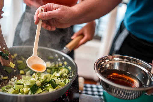 Close-up of the making of Chinese beef stir-fry with colorful vegetables and aromatic spices to create a taste sensation on a cooking class.