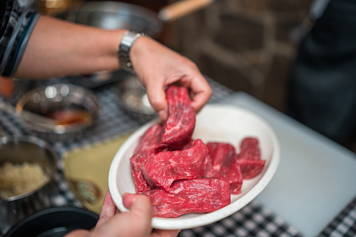 Close-up view of experiencing the art of Chinese cuisine as you skillfully prepare ingredients for a flavorful beef stir-fry delight on a cooking class.