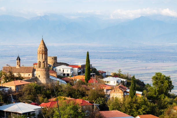 Sighnaghi town with cathedral over Alazan valley travel to Georgia - Sighnaghi town with cathedral over Alazan valley in Kakheti region in Georgia on sunny autumn evening kakheti georgia stock pictures, royalty-free photos & images
