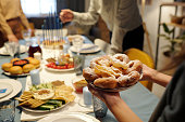 Close-up of unrecognizable girl holding plate with appetizing donuts