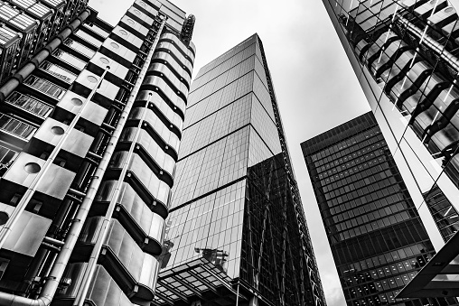 Modern black and white abstract reflections in glass fronted office buildings in the financial district of the British capital London.