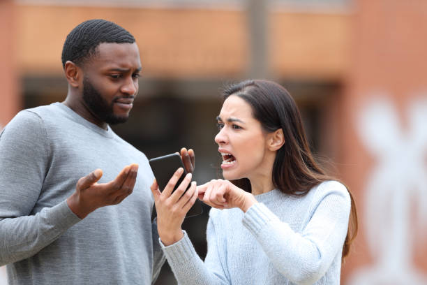 istock Angry woman scolding a man about phone content 1846930548