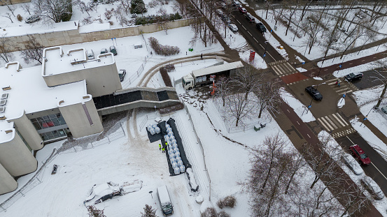 Drone photography of unloading packaging of a truck in a city during winter day