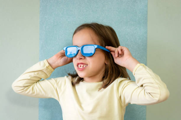 istock Cute girl whit colored blue sunglasses looking away. 1846936519
