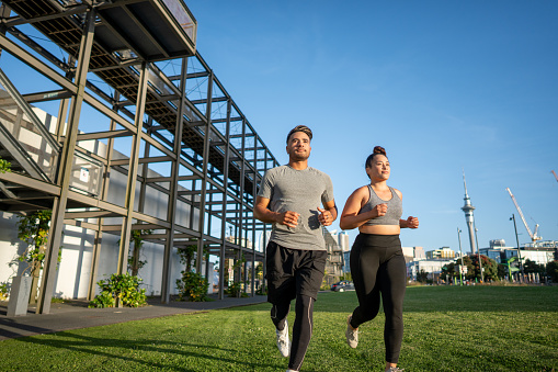 Two confident friends go for a run in the city