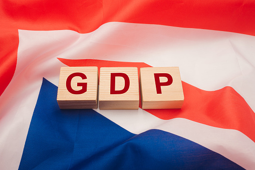 Gross Domestic Product (GDP) of Australia. Close-up of wooden cubes with the letters GDP on the Australia flag background. Business and growth of GDP concept